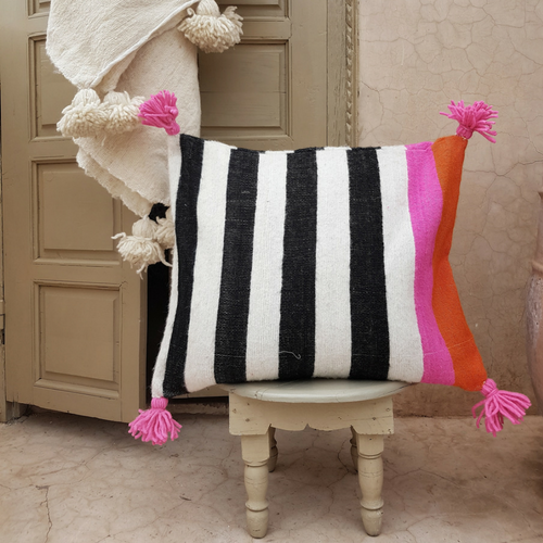 pompom blanket pillow with pink pompoms