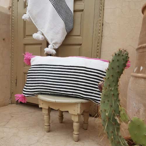 pompom blanket pillow with pink pompoms