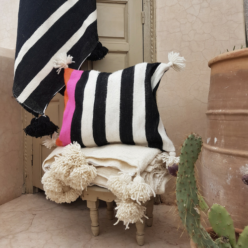 pompom blanket pillow with white pompoms