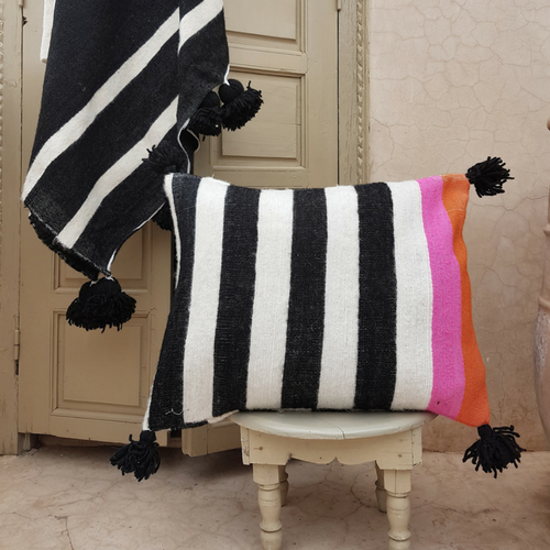 pompom blanket pillow with black pompoms