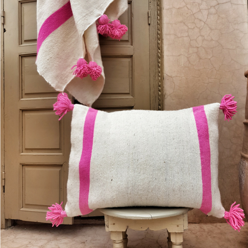 pompom blanket pillow with pink pompoms
